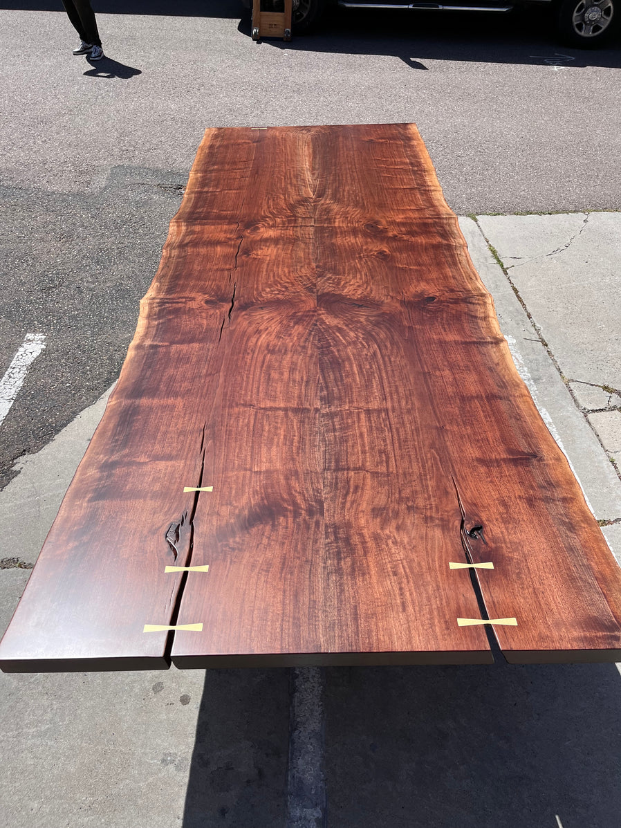 Live edge walnut bookmatched table top with solid bronze butterflies