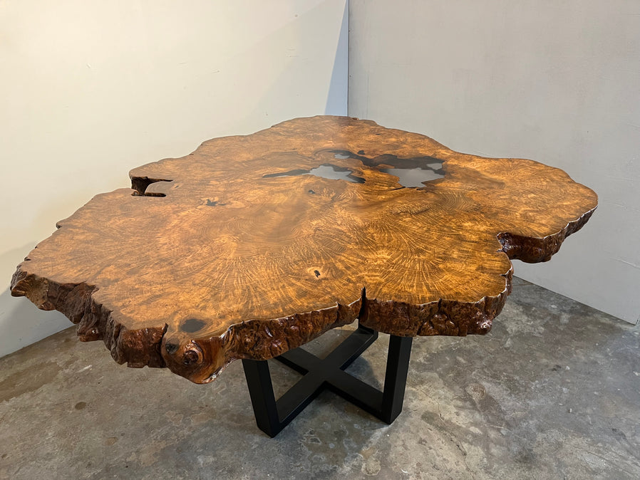 Teak Burl dining table with clear epoxy and steel base coated with oil rubbed bronze.