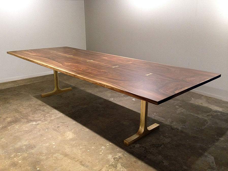 Straight edge rectangular 2 piece bookmatched walnut dining table with cast bronze T legs and bronze butterflies