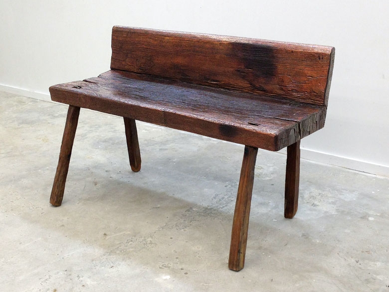 Teak village bench from Java, the seat and back are carved from the same piece of wood