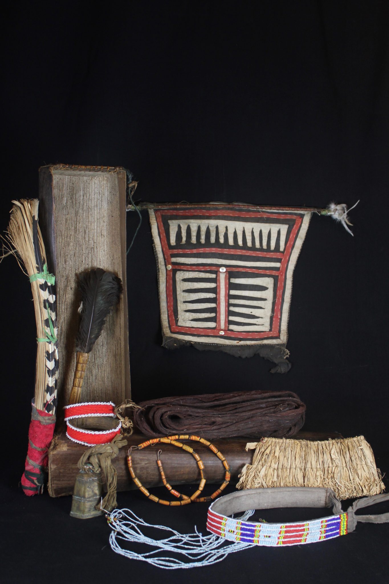Shaman Kit Box Contents, Mentawai Islands, Sumatra, Indonesia, Mentawai tribe Early to mid 20th c, Case: sago palm leaf box, braided rattan, Raffia wand handle and headband, feathers, European glass trade beads, cotton trade cloth, wood, bronze bell. Contents: costume (loincloth, jewelry, head gear) and wands. All items have a specific purpose - example: the beaded headband acts like antenna attracting spirits the shaman needs to contact. 5 ½” x 7 ½” x 30 ½” $3600.