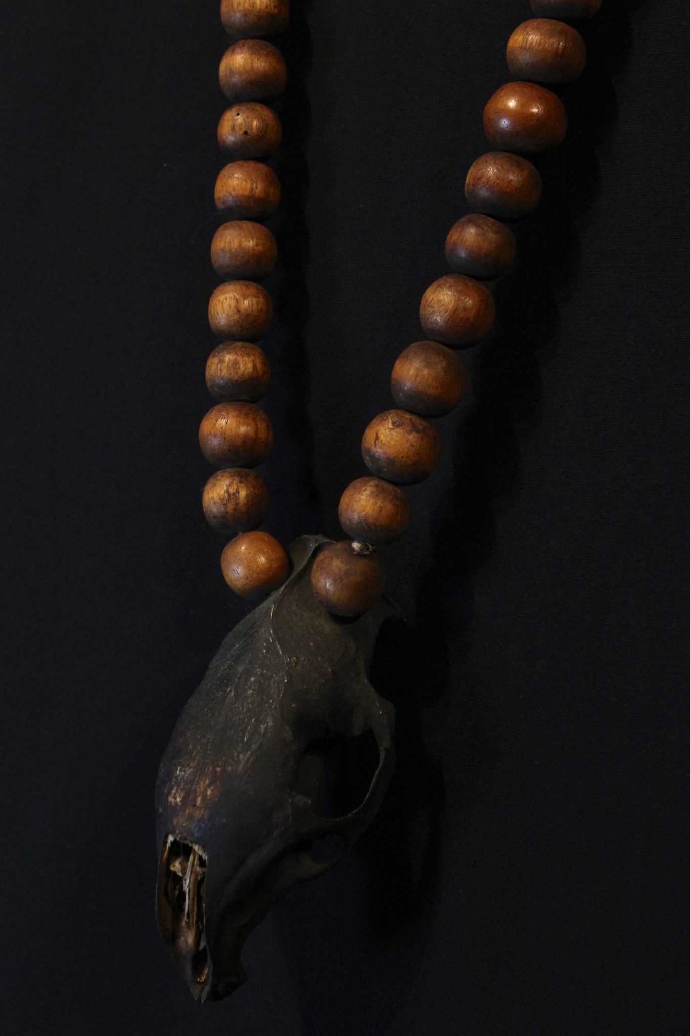 Skull Necklace Kalimantan, Borneo, Indonesia, Dayak tribe, Early 20th c, Wooden Beads, Rodent Skull, darkened with soot. Worn for healing and protection rituals 17 ½” x 2 ¾” x 1 ¾”, $450.