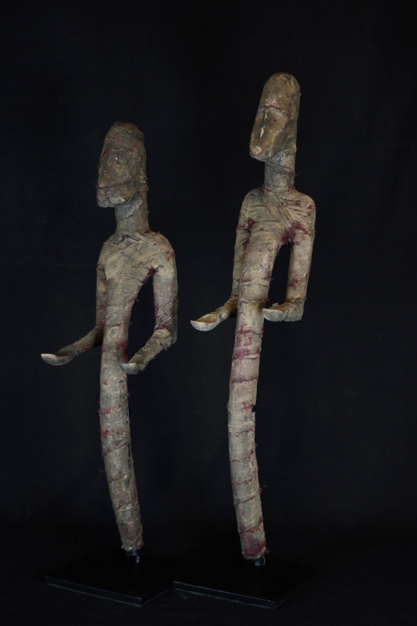 Shaman Figure (rare), Atauro Island, Lesser Sunda Islands, Indonesia Early 20th c. Wood, cloth. Used to protect people from harmful spirits during rituals. Faded and patinated with use and age, original red color of cloth still visible. Dimensions: (left - 22 ½” 5 ½’ x 7 ½”, $1200.); (right - 25 ¼’ x 4 ¼” x 6 ½”, $1200.)
