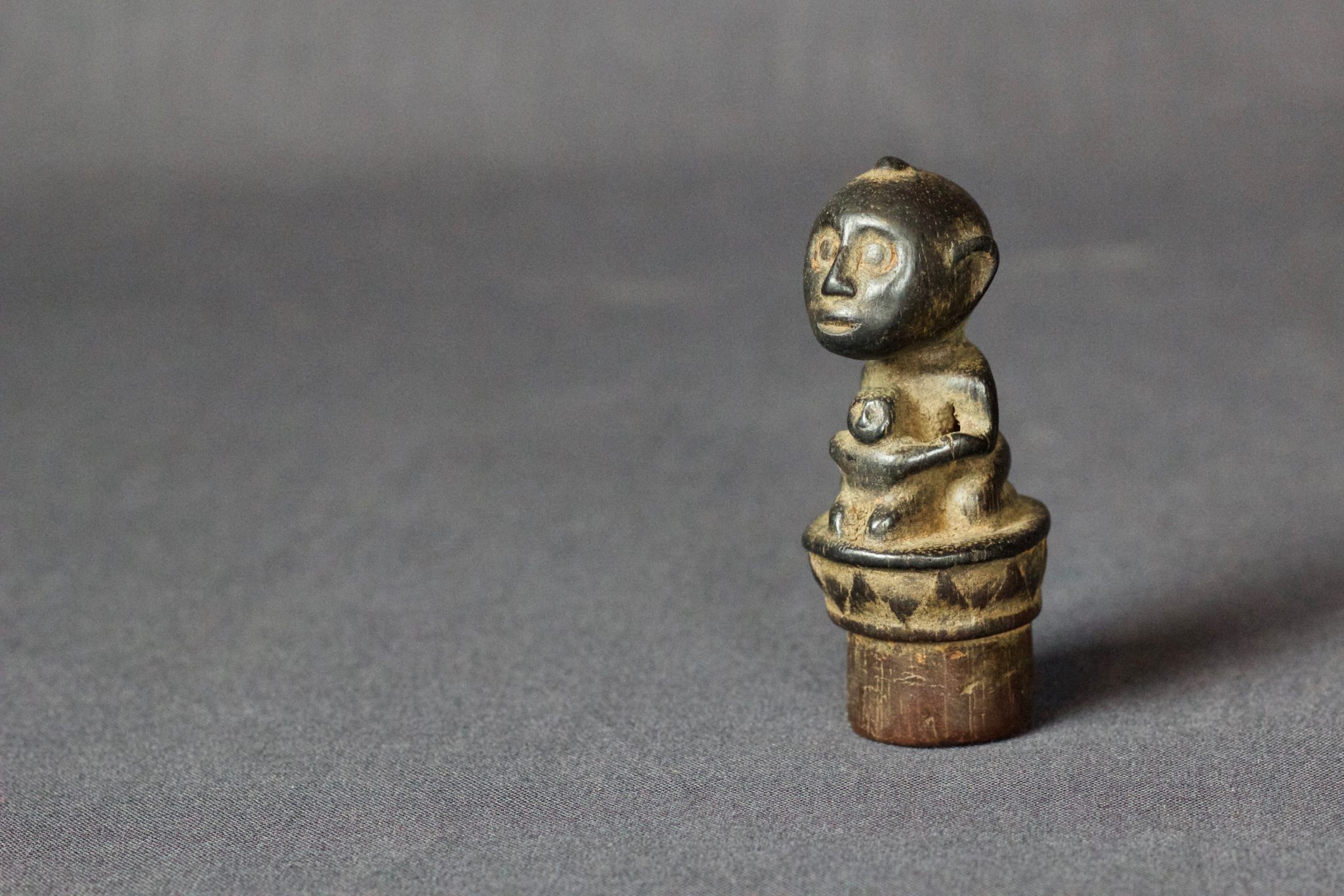 Shaman Magic Medicine Bottle Stopper, East Sumba Island, Lesser Sunda Islands, Indonesia Mid 19th c, Wood, patinated with use and age. Talisman figure with child, used empower the healing medicine in the bottle. 3” x 1 ¼” x 1 ¼”, $80.