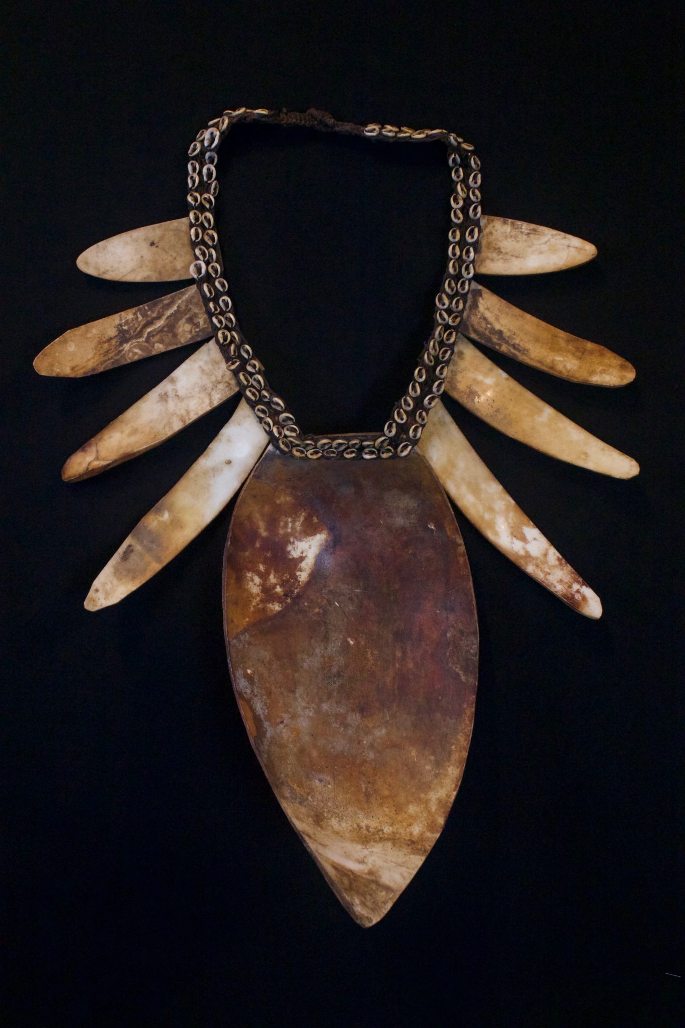 Shaman Shell Necklace, Papua New Guinea (Irian Jaya), Indonesia, Mid 20th c. Shell, cloth, fiber cord. Worn by the shaman for healing ceremonies. 19” x 15” x 3 ½” $850.