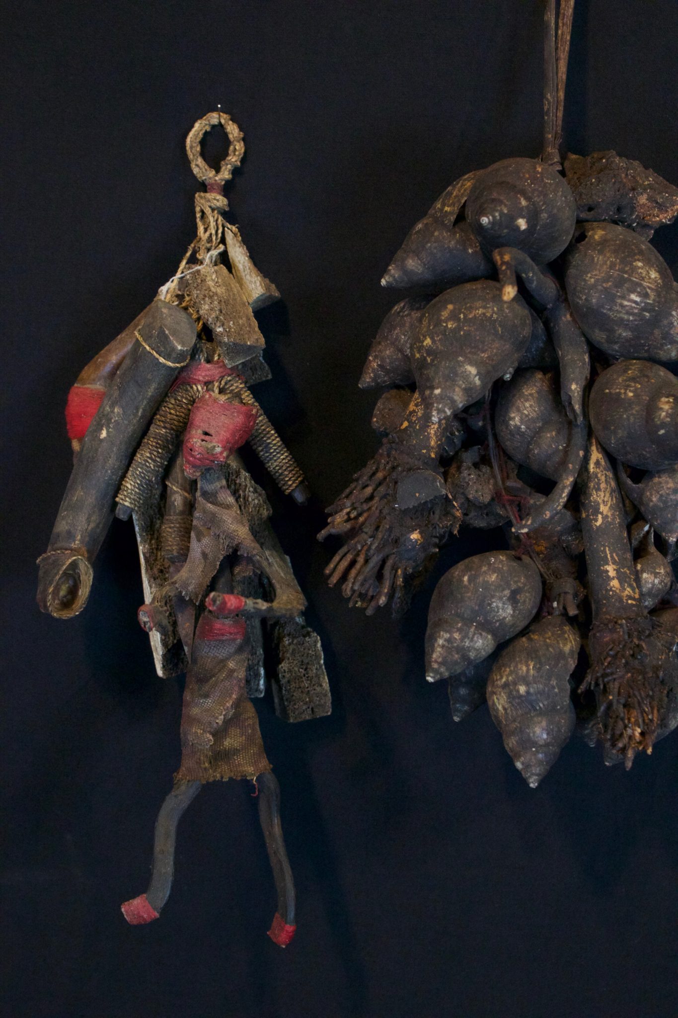 Shaman Healing Fetish Rattles, Lombok, Lesser Sunda Islands, Indonesia, Early to mid 20th c, Wood pigmented with soot, metal blade, cloth fiber, patinated with age and use. Used for healing rituals - Shaken to fend off harmful spirits. Dimensions: (left - 12” x 5 ½” x 4”, sold); (right - 14” x 7” x 6”, Sold)