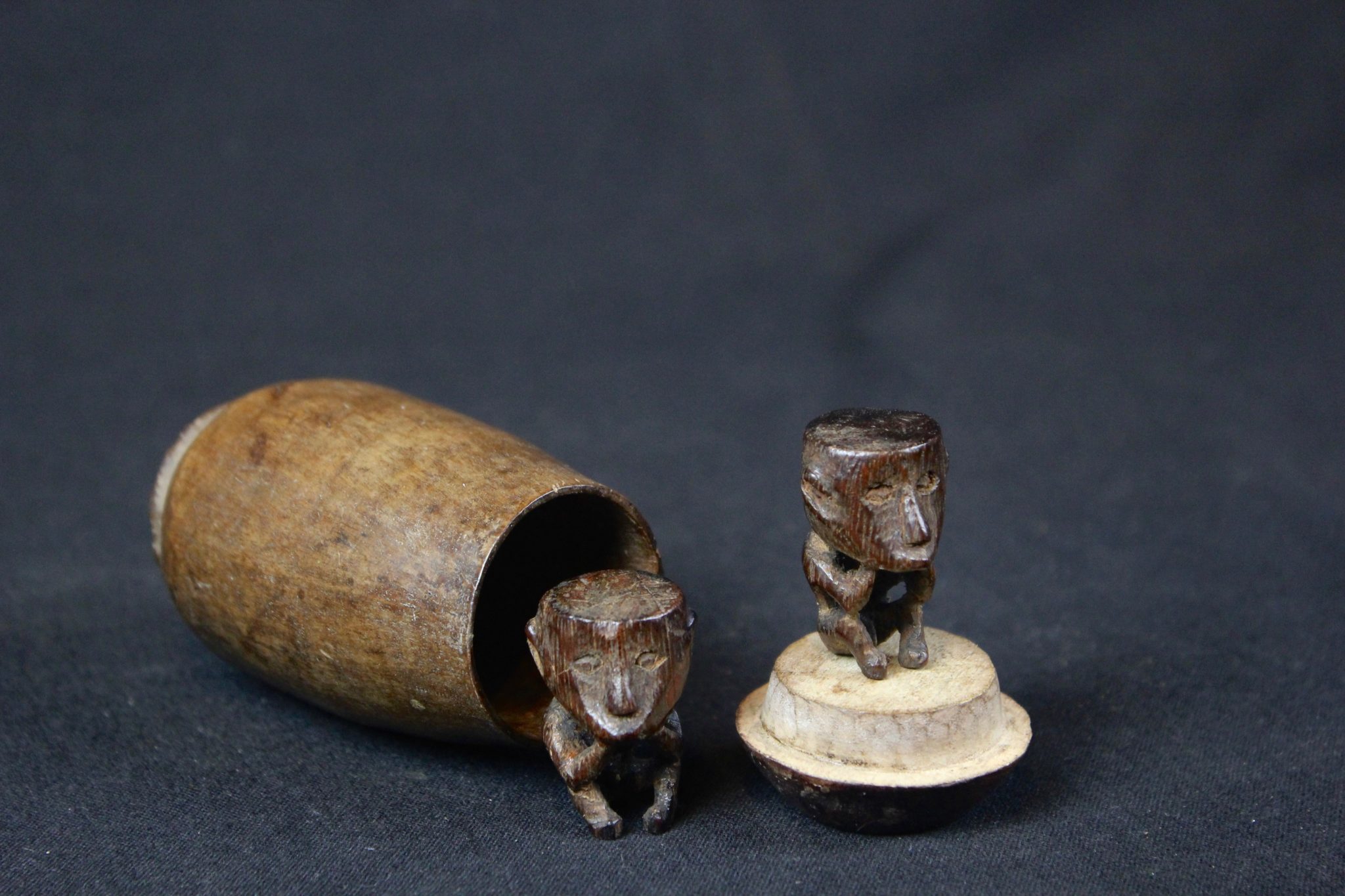 Shaman Charms, West Sumba Island, Lesser Sunda Islands, Indonesia, Lamboya village, Early 20th c, Wood, smooth patina from use and age. Healing amulets. 3 ½” x 2” x 2” (container); 1 ¼” x ¾’ x ½” (each figure), $375.