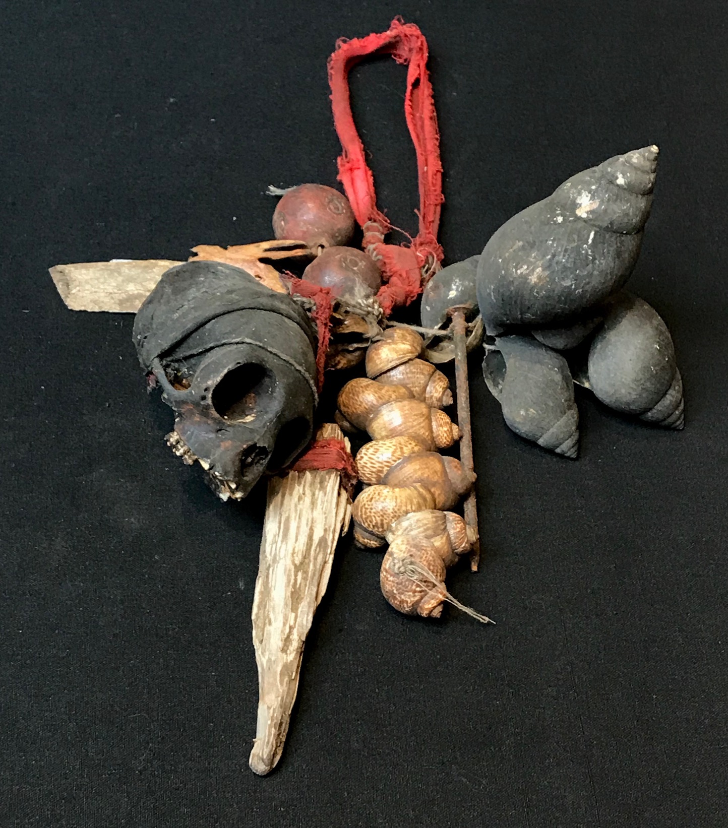 Shaman's ritual dance rattle, Indonesia, Borneo, Dayak tribe, early 20th c., Monkey skull, sea shells, metal nail, ceramic beads, glass bead, Shaken to scare away evil or harmful spirits, 12" x 7" 