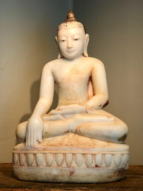 Marble Buddha, Shan Style, 17th century. Hand carved with a smooth finish and painted with gold gilt and red pigment. Museum quality condition, wear is consistent with age. Buddha is sitting in the lotus position (legs crossed with soles of feet up) with hands in 'Bhumisparsha mudra' position - calling the earth to witness his enlightenment. Seated on a Lotus design base. His serene demeanor and monastic robes show great carving skill and artistry. Dimensions: 32" tall x 21.5 wide x 13.5 deep. $34,000.